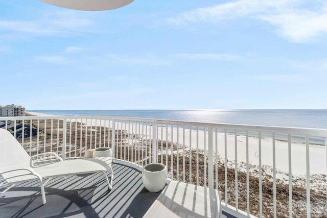 balcony featuring a water view and a view of the beach