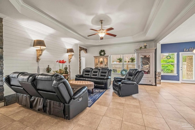 5409 Dalton Cir, Milton, FL 32570 - living room featuring a raised ceiling, light tile patterned floors, a ceiling fan, and crown molding