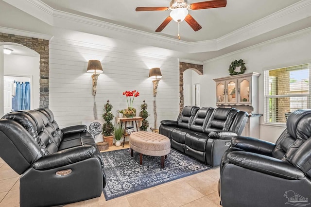 5409 Dalton Cir, Milton, FL 32570 - living room featuring arched walkways, light tile patterned floors, a ceiling fan, crown molding, and wood walls