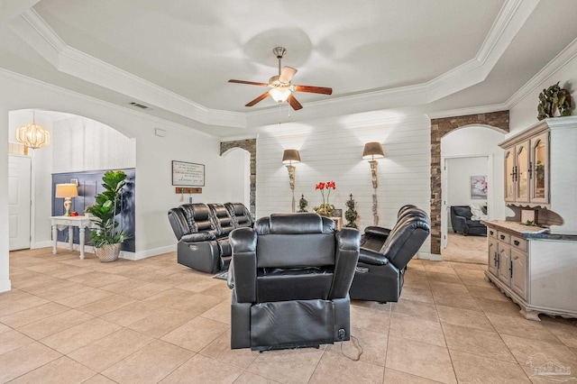5409 Dalton Cir, Milton, FL 32570 - living room featuring arched walkways, a tray ceiling, a ceiling fan, crown molding, and light tile patterned flooring