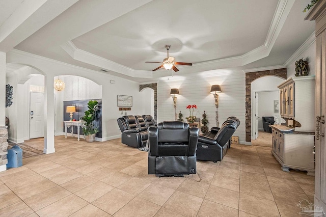 5409 Dalton Cir, Milton, FL 32570 - living room featuring arched walkways, a raised ceiling, ceiling fan, ornamental molding, and light tile patterned flooring