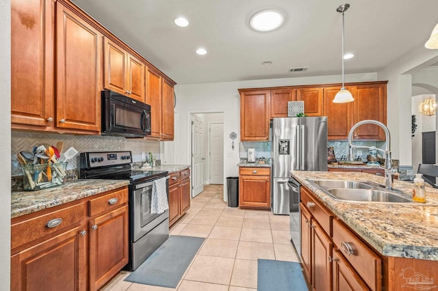 5409 Dalton Cir, Milton, FL 32570 - kitchen with appliances with stainless steel finishes, brown cabinets, decorative backsplash, and recessed lighting