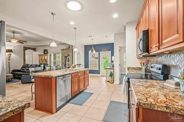 5409 Dalton Cir, Milton, FL 32570 - kitchen featuring dishwasher, black microwave, electric range, brown cabinets, and light tile patterned flooring