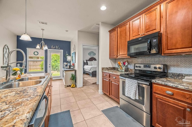 5409 Dalton Cir, Milton, FL 32570 - kitchen featuring appliances with stainless steel finishes, backsplash, decorative light fixtures, light tile patterned floors, and brown cabinetry