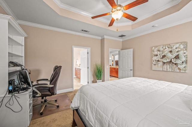 5409 Dalton Cir, Milton, FL 32570 - bedroom featuring a tray ceiling, light carpet, an office area, ornamental molding, and ensuite bath