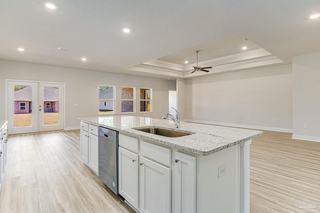 kitchen featuring a sink, a wealth of natural light, open floor plan, and dishwasher