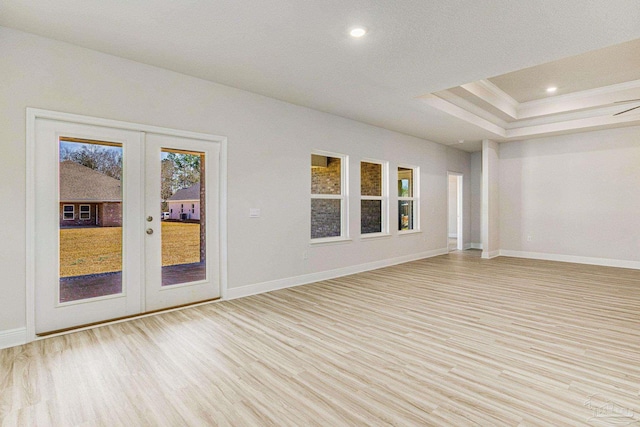 unfurnished room with recessed lighting, light wood-style flooring, baseboards, and french doors