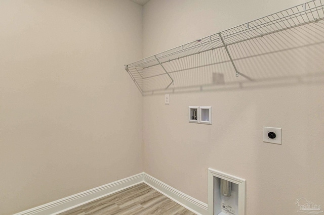 laundry area featuring washer hookup, electric dryer hookup, light wood-type flooring, laundry area, and baseboards