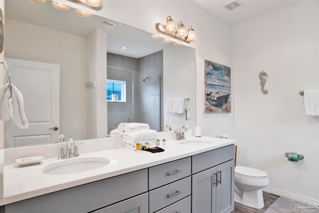 bathroom with vanity, toilet, wood-type flooring, and an enclosed shower