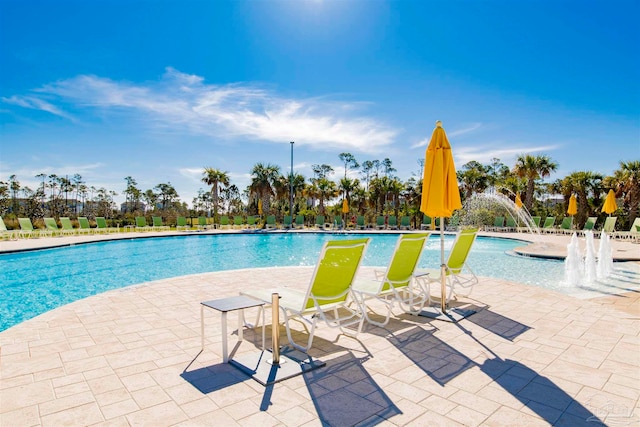 view of swimming pool featuring pool water feature and a patio area