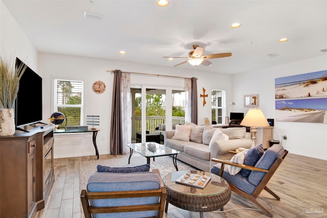 living room with ceiling fan and light wood-type flooring