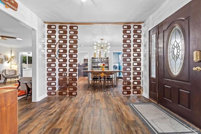 entryway with dark wood finished floors, a textured ceiling, baseboards, and ceiling fan