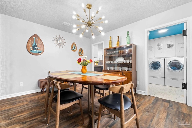 dining space featuring baseboards, dark wood finished floors, independent washer and dryer, a textured ceiling, and a notable chandelier