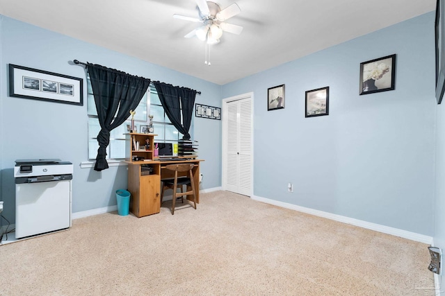 office area with baseboards, a ceiling fan, and light colored carpet