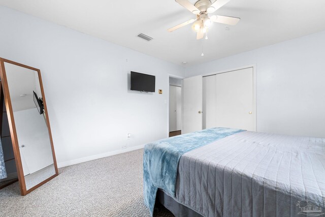 carpeted bedroom featuring baseboards, visible vents, ceiling fan, and a closet