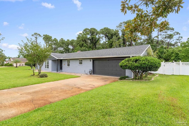 single story home with a front yard, fence, driveway, and an attached garage