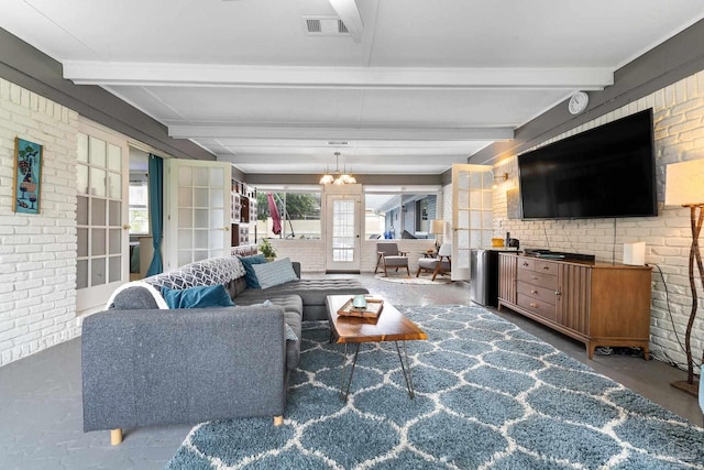 living room with beam ceiling, visible vents, and brick wall