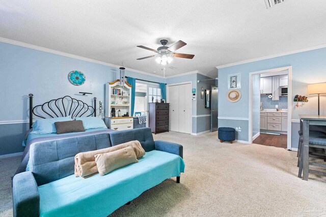 bedroom with light carpet, baseboards, ceiling fan, a textured ceiling, and crown molding