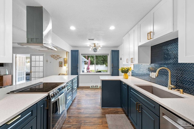 kitchen with a sink, stainless steel appliances, exhaust hood, and light countertops