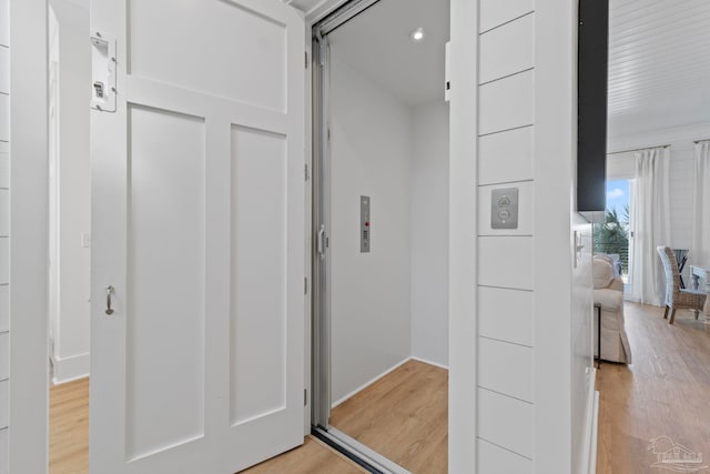 hallway with light wood-style floors