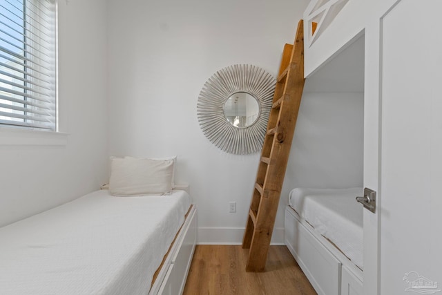 bedroom featuring dark wood-type flooring and baseboards