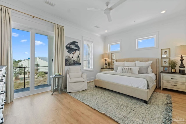 bedroom featuring visible vents, wood finished floors, a ceiling fan, and access to outside