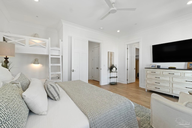 bedroom with a ceiling fan, recessed lighting, light wood-style floors, crown molding, and baseboards