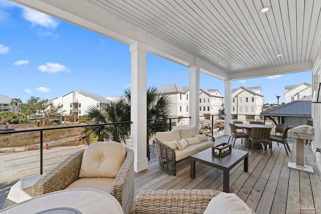 wooden deck with outdoor dining space, an outdoor living space, and a residential view