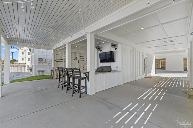 view of patio / terrace with outdoor dry bar and fence