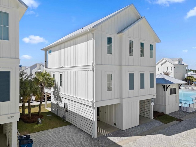 view of home's exterior featuring decorative driveway and board and batten siding