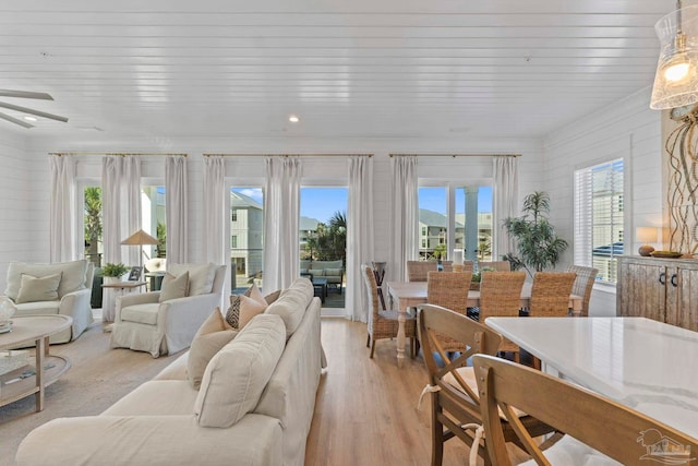 living room with light wood-type flooring and wood ceiling