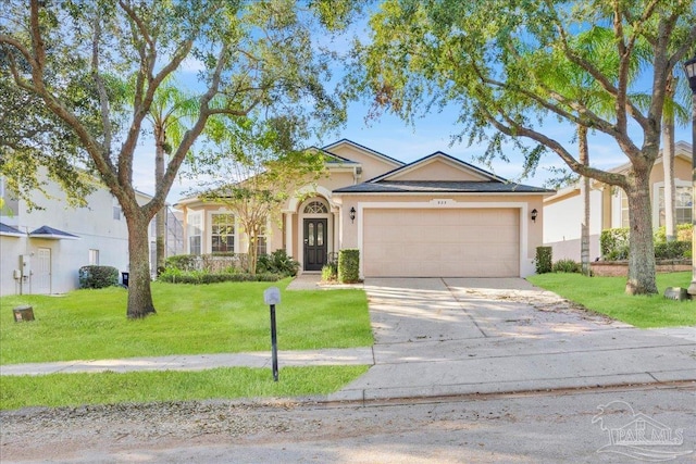 view of front of home featuring a front yard and a garage