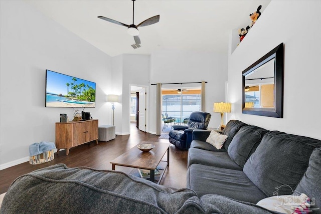 living room with dark wood-type flooring, high vaulted ceiling, and ceiling fan