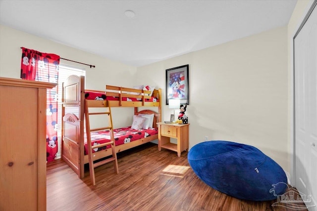 bedroom with hardwood / wood-style flooring and a closet