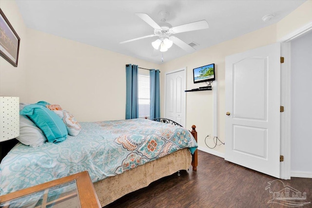 bedroom featuring dark hardwood / wood-style flooring, a closet, and ceiling fan