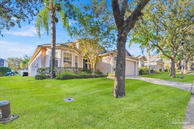 view of front of property with a front yard and a garage