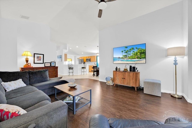 living room with dark hardwood / wood-style floors, vaulted ceiling, and ceiling fan