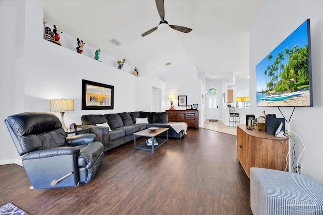 living room with dark hardwood / wood-style floors, vaulted ceiling, and ceiling fan