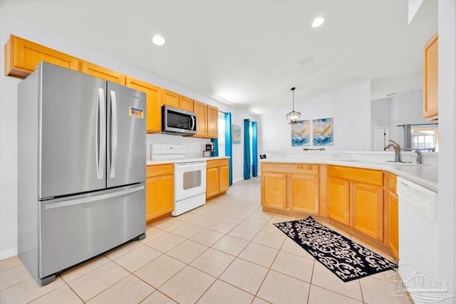 kitchen featuring appliances with stainless steel finishes, sink, pendant lighting, light tile patterned floors, and a chandelier