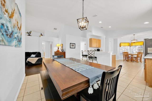 dining room featuring a notable chandelier and light tile patterned flooring