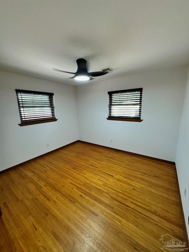 7920 Reeders Ln, Pensacola, FL 32526 - spare room with ceiling fan, wood finished floors, and baseboards