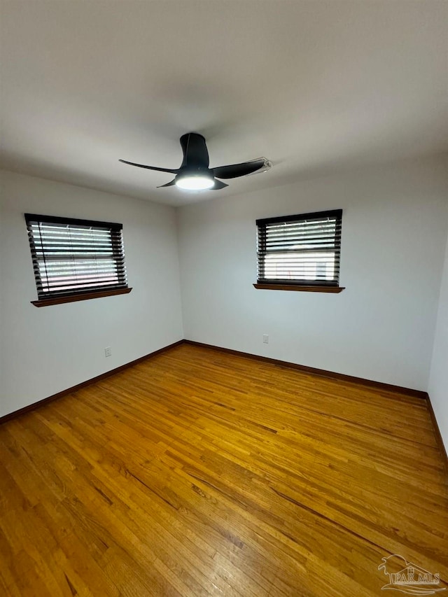 spare room featuring ceiling fan and light hardwood / wood-style flooring