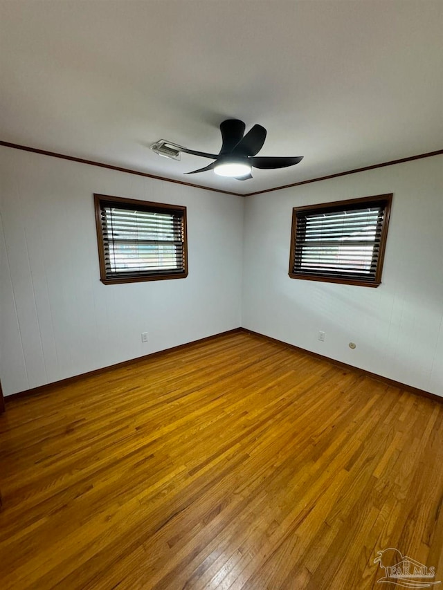 spare room with wood-type flooring and ceiling fan