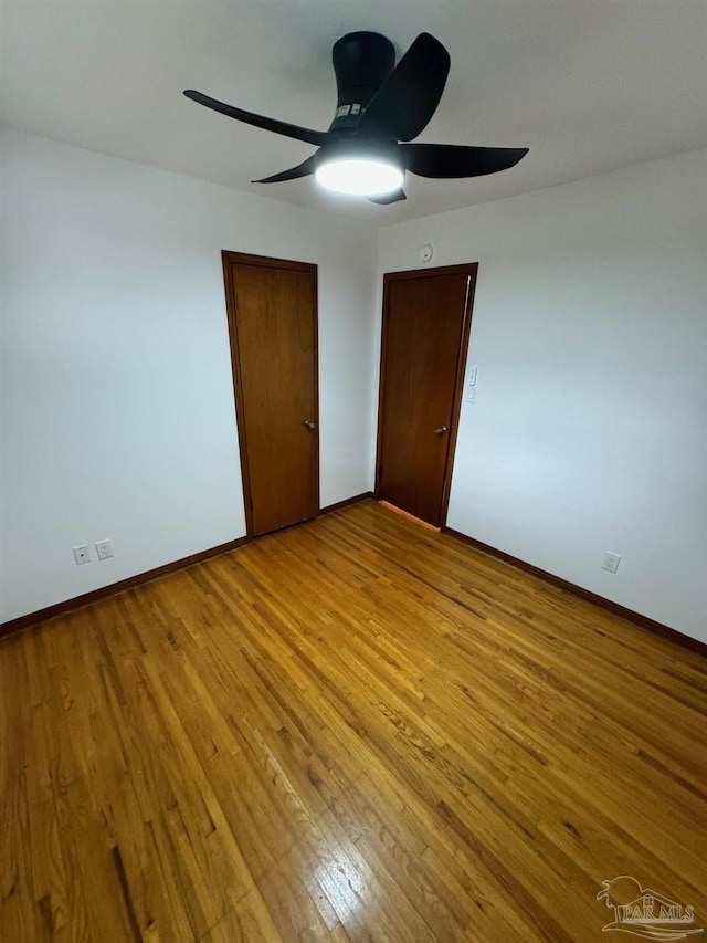 7920 Reeders Ln, Pensacola, FL 32526 - unfurnished bedroom featuring light wood-style flooring, baseboards, and a ceiling fan