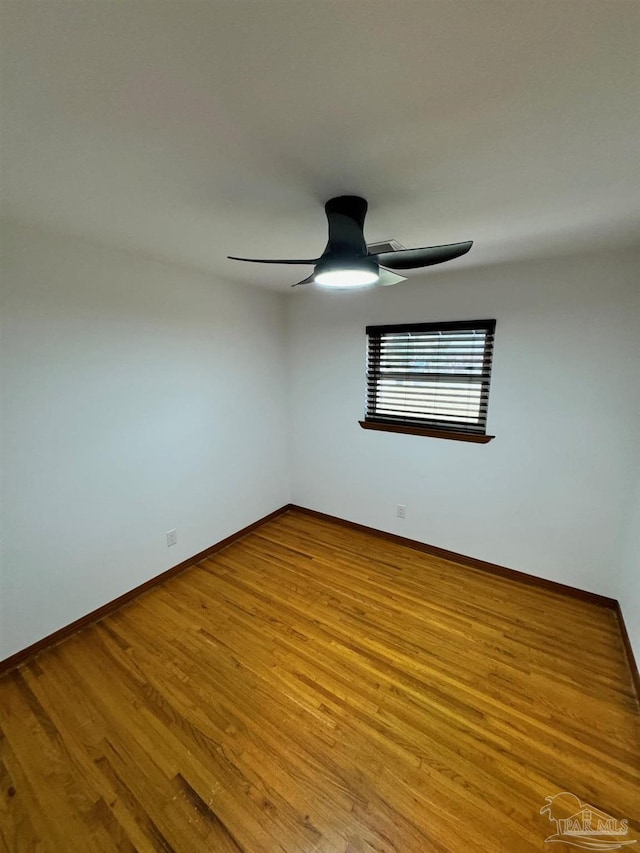7920 Reeders Ln, Pensacola, FL 32526 - spare room featuring baseboards, wood finished floors, and a ceiling fan