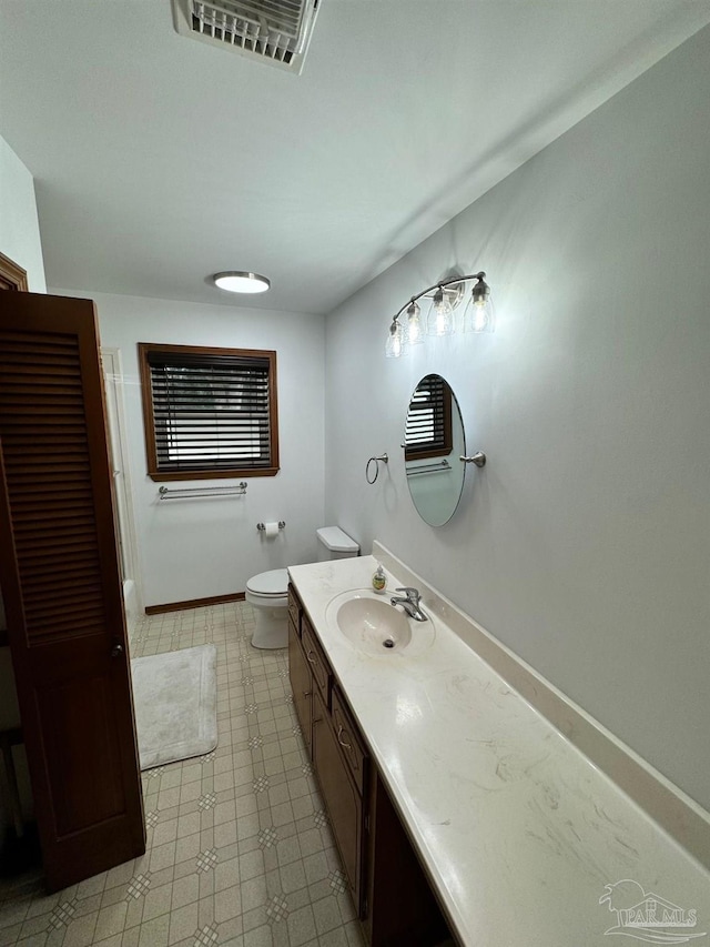 7920 Reeders Ln, Pensacola, FL 32526 - bathroom featuring vanity, toilet, and baseboards