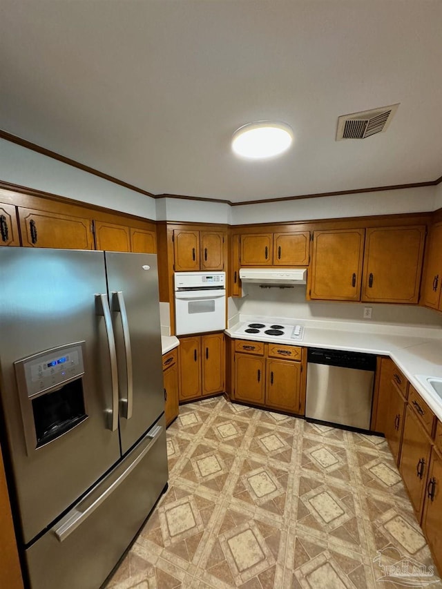 7920 Reeders Ln, Pensacola, FL 32526 - kitchen featuring appliances with stainless steel finishes, brown cabinets, under cabinet range hood, light countertops, and crown molding