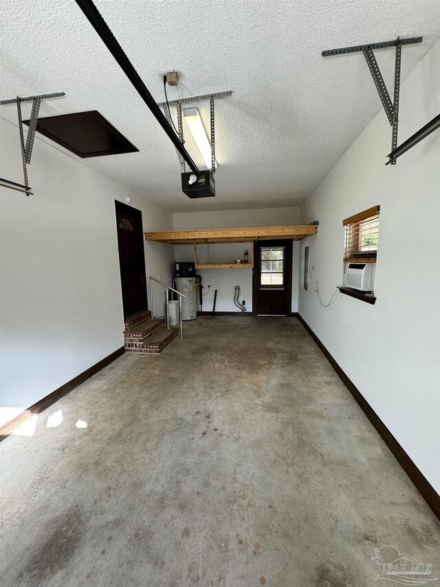 7920 Reeders Ln, Pensacola, FL 32526 - garage featuring a garage door opener, heat pump water heater, baseboards, and cooling unit