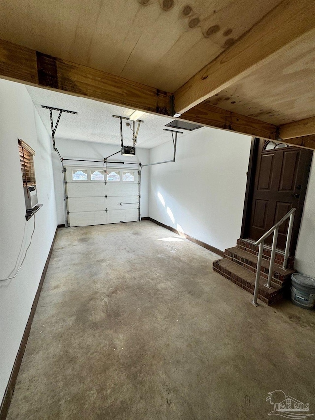 7920 Reeders Ln, Pensacola, FL 32526 - garage featuring a garage door opener and baseboards