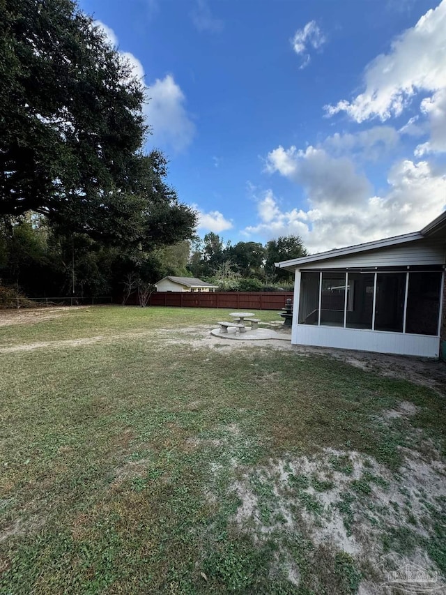 view of yard featuring a sunroom